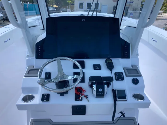  Yacht Photos Pics 2025 Aquasport 28AS boat dashboard with steering wheel and control panel.
