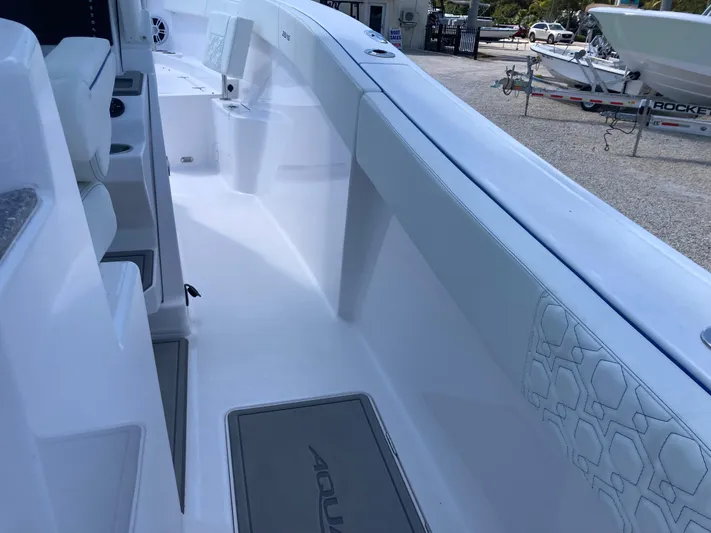  Yacht Photos Pics 2025 Aquasport 28AS boat interior with sleek white design and spacious deck.