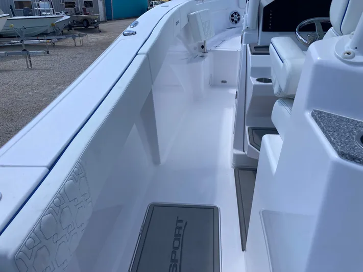  Yacht Photos Pics 2025 Aquasport 28AS boat interior, featuring sleek white design and modern seating.
