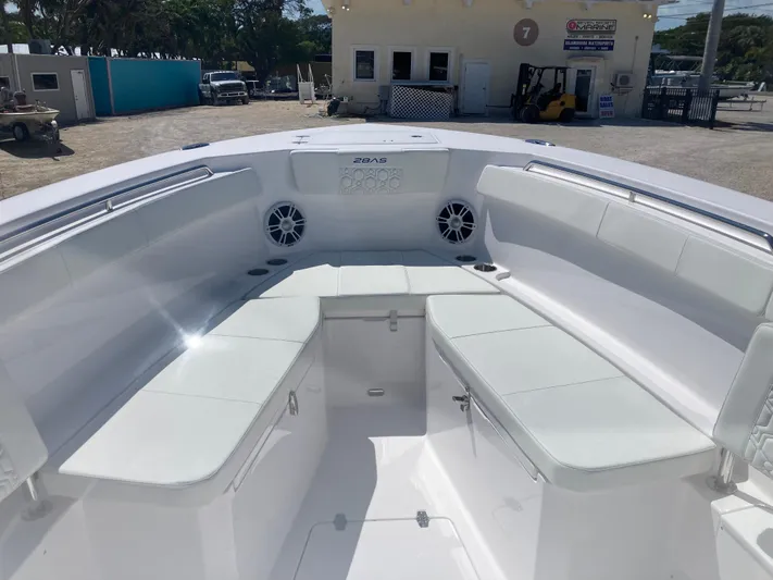  Yacht Photos Pics 2025 Aquasport 28AS boat interior with white seating and speakers.