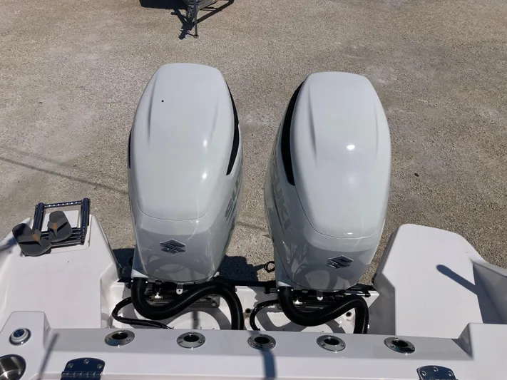  Yacht Photos Pics Twin outboard engines on a 2025 Aquasport 28AS boat, viewed from above.