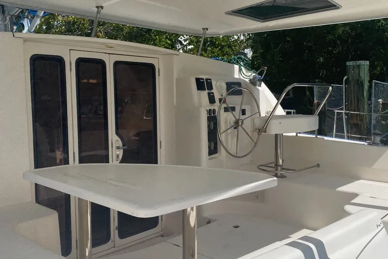 Tiki Yacht Photos Pics 2003 Leopard 38 yacht cockpit with steering wheel and seating area.