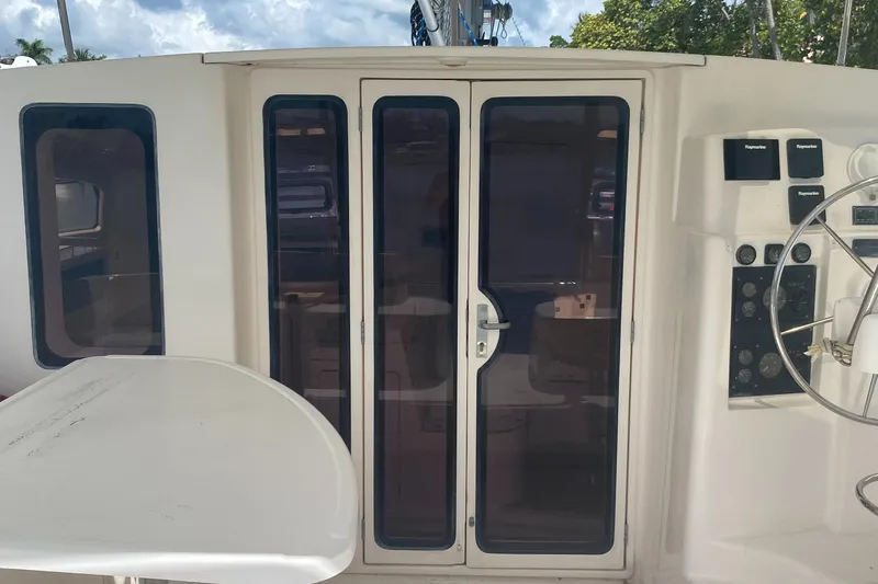 Tiki Yacht Photos Pics 2003 Leopard 38 yacht cockpit with glass doors and steering wheel.