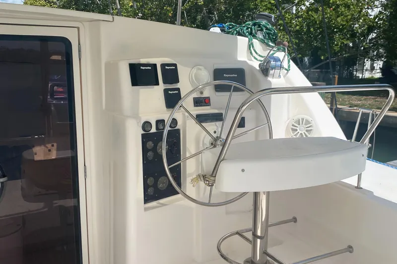 Tiki Yacht Photos Pics Steering wheel and controls of a 2003 Leopard 38 catamaran yacht.