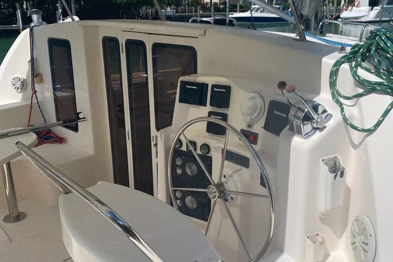 Tiki Yacht Photos Pics Helm of 2003 Leopard 38 catamaran with steering wheel and navigation instruments.