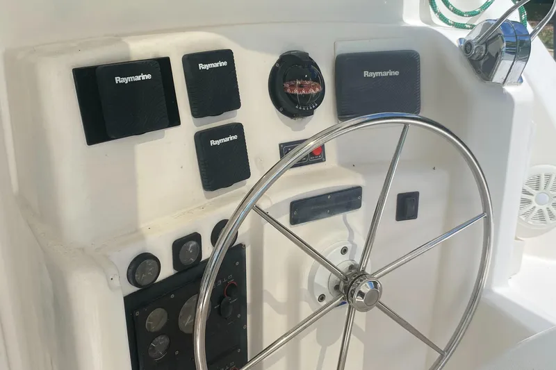 Tiki Yacht Photos Pics Steering wheel and controls of a 2003 Leopard 38 catamaran.