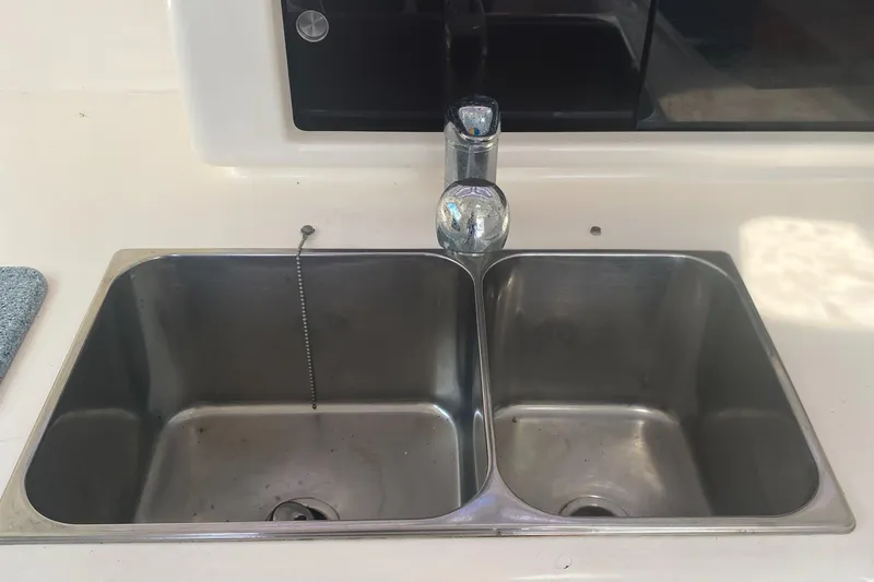 Tiki Yacht Photos Pics Stainless steel double sink on a 2003 Leopard 38 yacht.