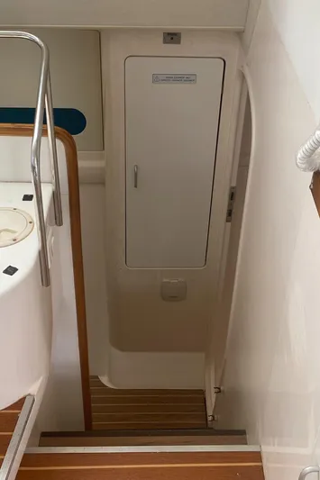 Tiki Yacht Photos Pics Staircase leading to cabin on 2003 Leopard 38 yacht, featuring wooden steps and white walls.