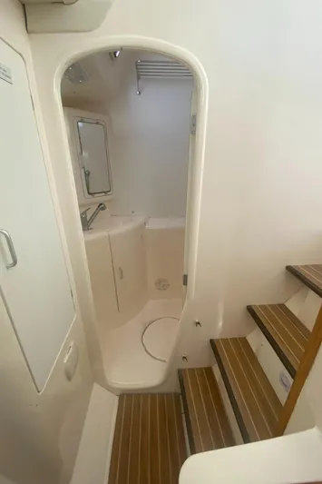 Tiki Yacht Photos Pics 2003 Leopard 38 yacht interior with wooden steps and compact bathroom.