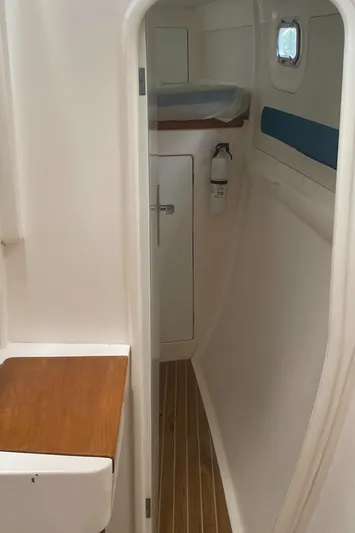Tiki Yacht Photos Pics Interior of a 2003 Leopard 38 yacht, featuring a narrow hallway and wooden flooring.