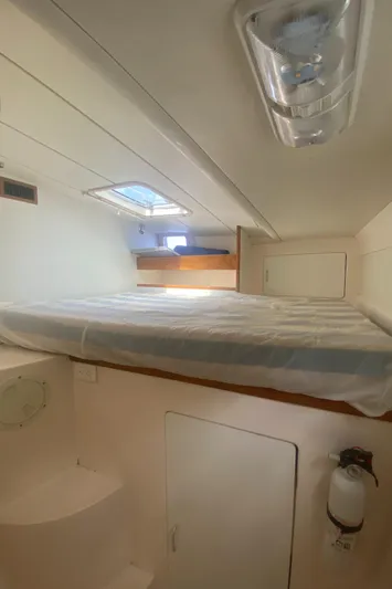 Tiki Yacht Photos Pics 2003 Leopard 38 yacht interior cabin with bed and storage.