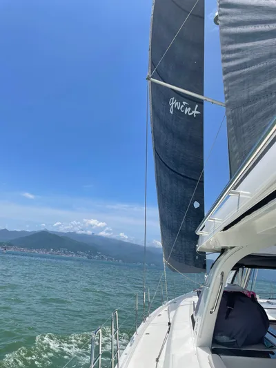 Gwint Yacht Photos Pics 2019 Beneteau Oceanis Yacht 62 sailing on open water under clear blue skies.