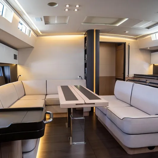 Gwint Yacht Photos Pics Luxurious interior of 2019 Beneteau Oceanis Yacht 62 with modern seating and elegant lighting.