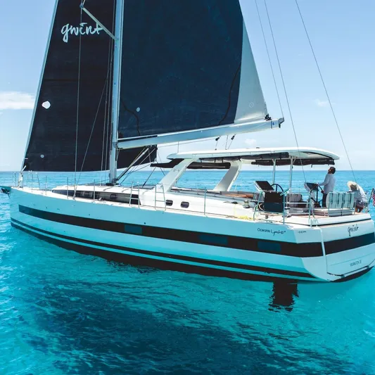 Gwint Yacht Photos Pics 2019 Beneteau Oceanis Yacht 62 sailing on clear blue waters.