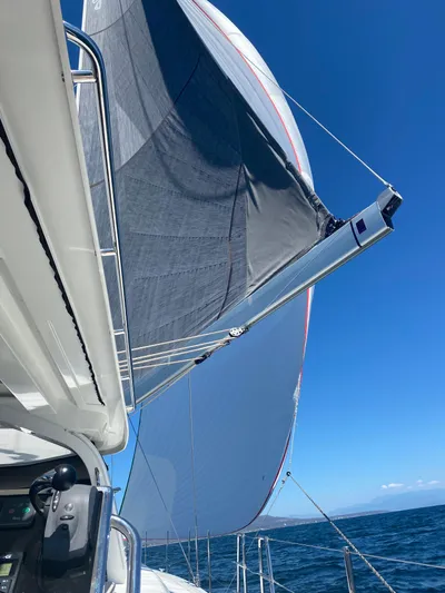Gwint Yacht Photos Pics 2019 Beneteau Oceanis Yacht 62 sailing with full sails under clear blue sky.