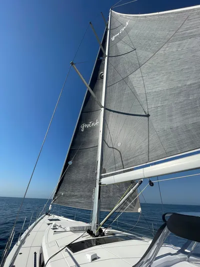 Gwint Yacht Photos Pics 2019 Beneteau Oceanis Yacht 62 sailing on open sea under clear blue sky.