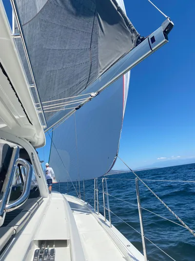Gwint Yacht Photos Pics 2019 Beneteau Oceanis Yacht 62 sailing on open sea under clear blue sky.