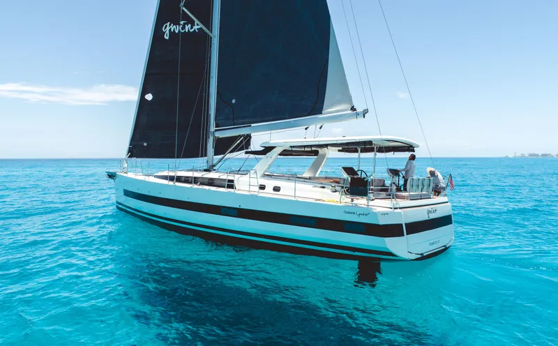 Gwint Yacht Photos Pics 2019 Beneteau Oceanis Yacht 62 sailing on clear blue waters.