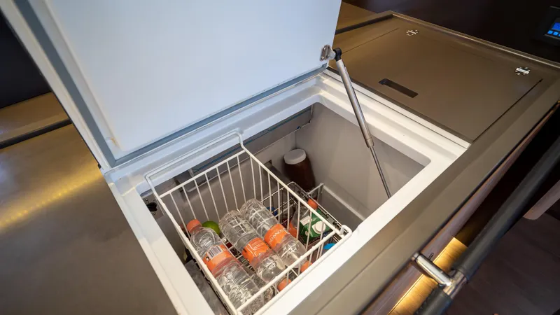 Gwint Yacht Photos Pics Built-in refrigerator on 2019 Beneteau Oceanis Yacht 62, stocked with beverages.