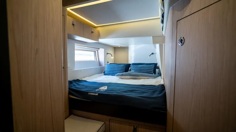 Gwint Yacht Photos Pics Luxurious cabin interior of 2019 Beneteau Oceanis Yacht 62 with modern design and cozy bedding.