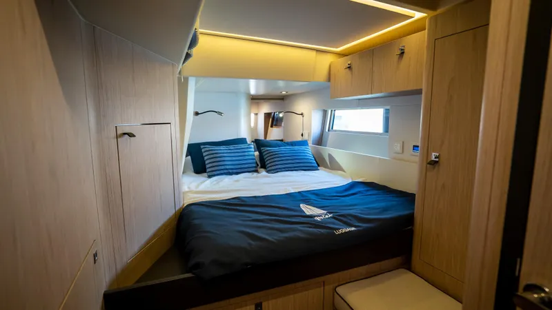 Gwint Yacht Photos Pics Luxurious cabin interior of 2019 Beneteau Oceanis Yacht 62 with modern design and cozy bedding.