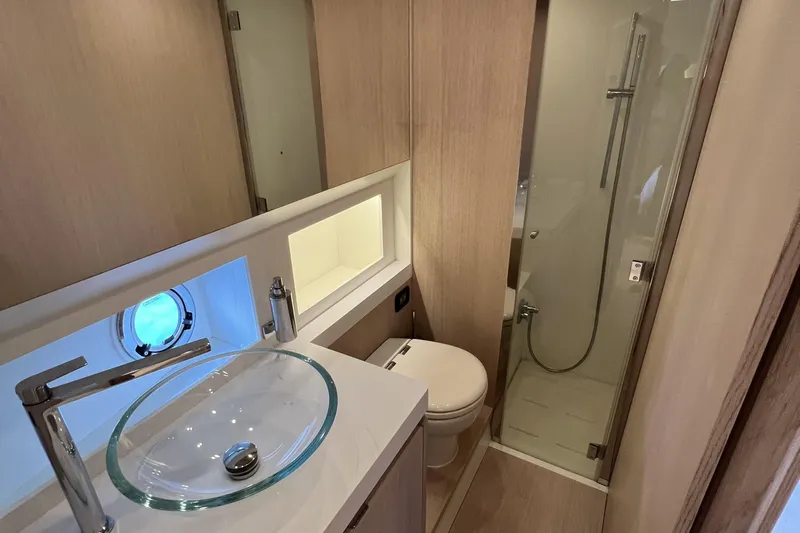  Yacht Photos Pics Luxurious bathroom in 2021 Solaris Power 48 OPEN yacht with glass sink and shower.