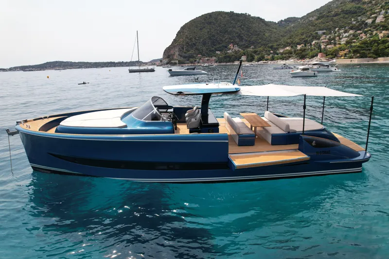  Yacht Photos Pics 2021 Solaris Power 48 OPEN yacht on serene blue waters, surrounded by lush hills.