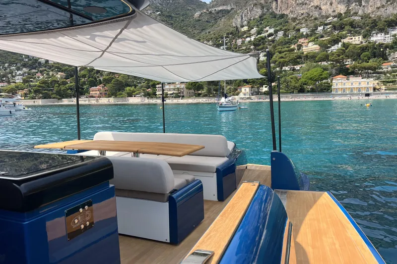  Yacht Photos Pics Luxurious 2021 Solaris Power 48 OPEN yacht with elegant seating, scenic coastal backdrop.