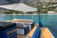 Luxurious 2021 Solaris Power 48 OPEN yacht with elegant seating, scenic coastal backdrop.
