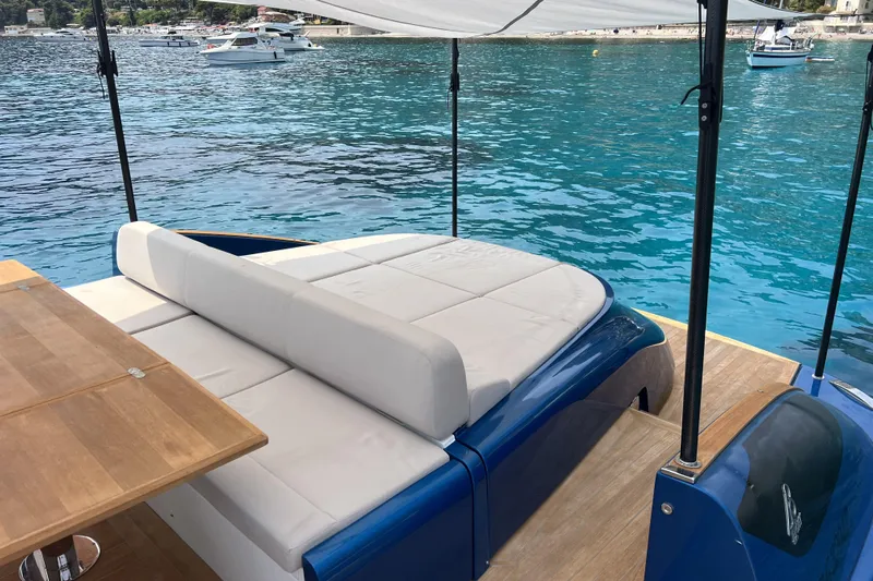  Yacht Photos Pics Luxurious Solaris Power 48 OPEN yacht, 2021 model, with sunbed and wooden deck by the sea.