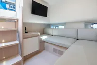 Interior of 2021 Solaris Power 48 OPEN yacht with modern seating and TV.