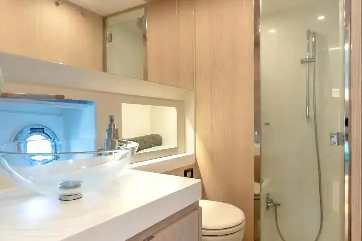  Yacht Photos Pics Luxurious bathroom in 2021 Solaris Power 48 OPEN yacht with modern fixtures and glass shower.