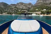 2021 Solaris Power 48 OPEN yacht cruising near scenic coastal cliffs.
