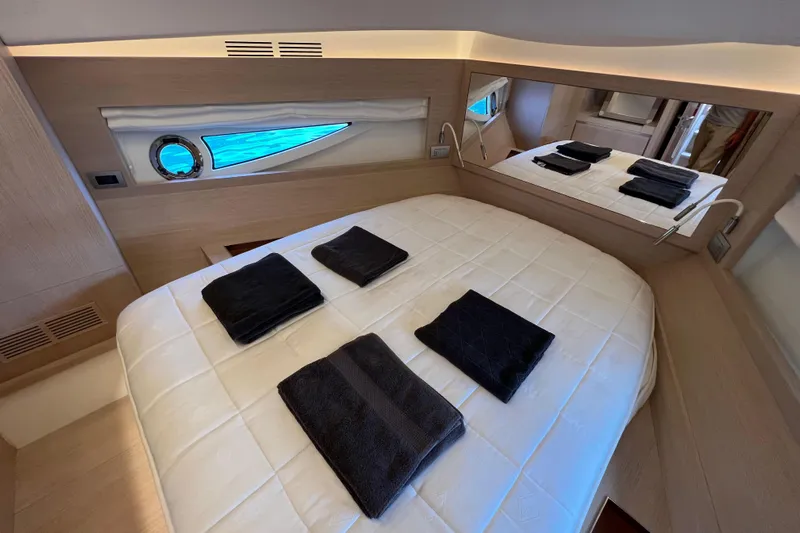  Yacht Photos Pics Luxurious cabin interior of 2021 Solaris Power 48 OPEN yacht with elegant bedding.