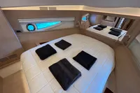 Luxurious cabin interior of 2021 Solaris Power 48 OPEN yacht with elegant bedding.