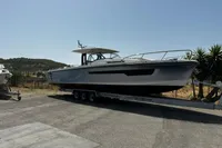 2024 Nimbus T11 X-Edition boat on trailer, parked outdoors under clear sky.