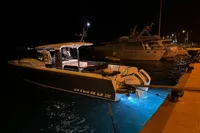 2024 Nimbus T11 X-Edition boat docked at night with underwater lights.