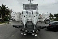2024 Nimbus T11 X-Edition boat with dual engines, parked on a street, overcast sky.