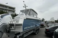 2024 Nimbus T11 X-Edition boat on trailer, parked near a marina with overcast sky.