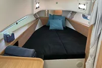 2024 Nimbus T11 X-Edition cabin with cozy bed, wooden accents, and modern design.