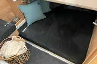 Cozy cabin interior of 2024 Nimbus T11 X-EDITION with cushions and woven basket.