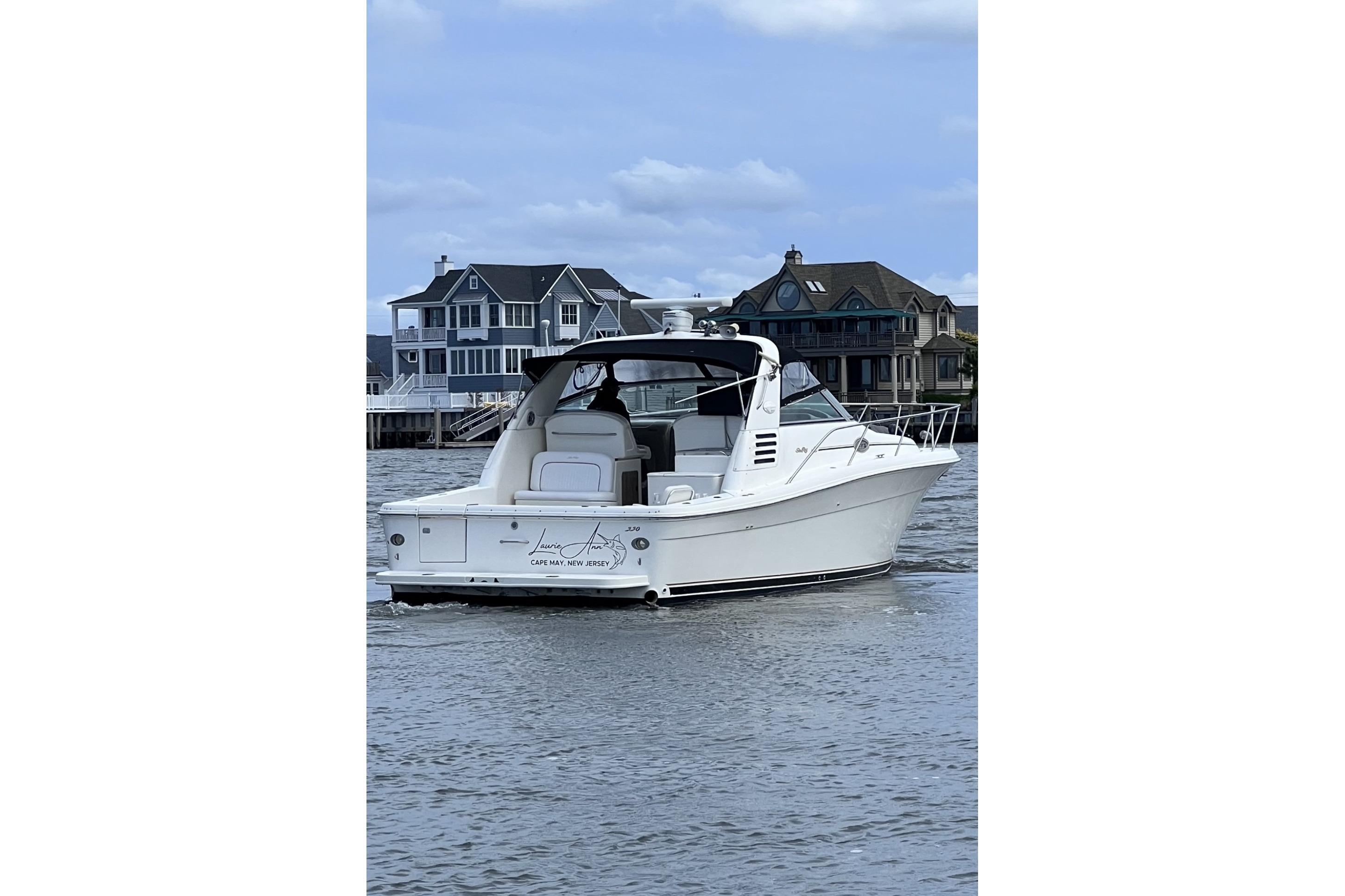 1998 Sea Ray 340 Amberjack boat on water near coastal homes.