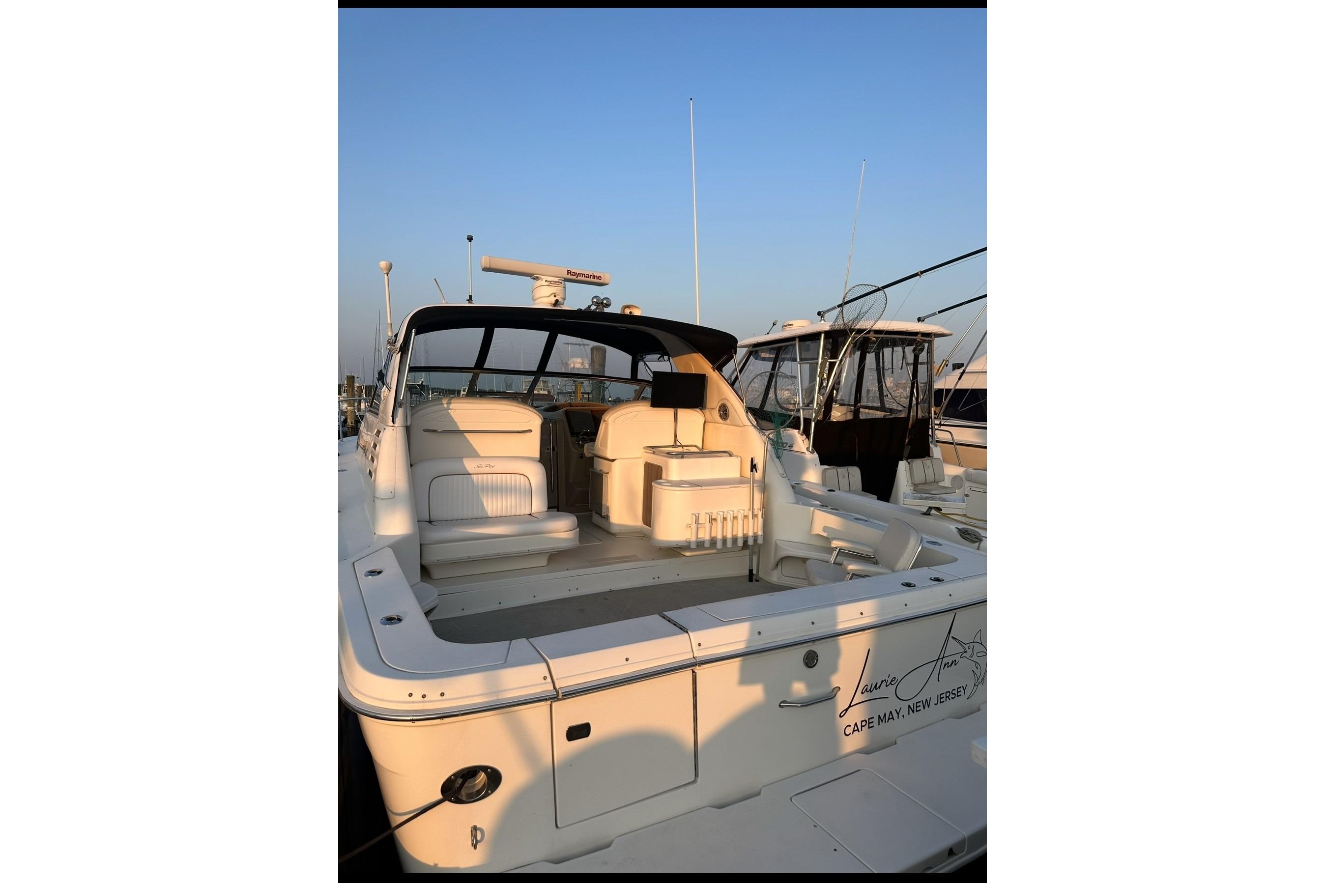 1998 Sea Ray 340 Amberjack boat docked, featuring spacious seating and sleek design.