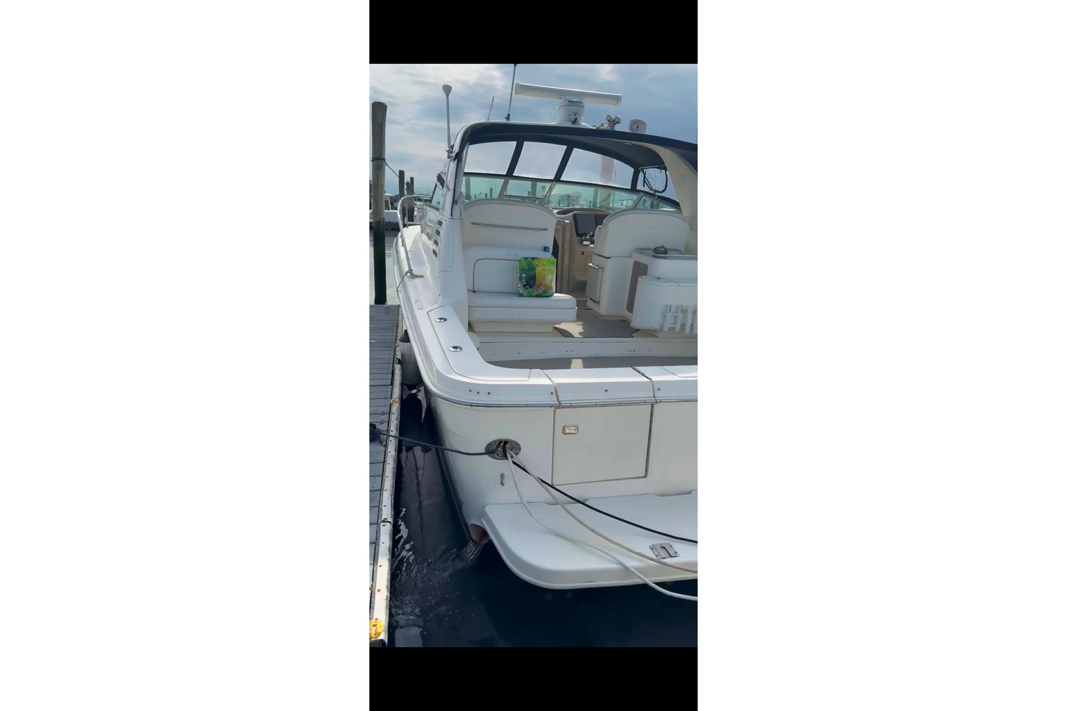 1998 Sea Ray 340 Amberjack docked, showcasing spacious deck and seating area.