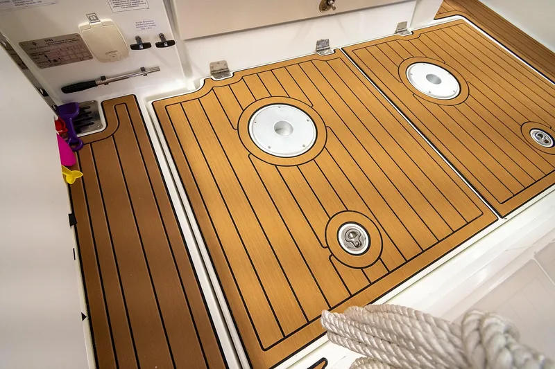  Yacht Photos Pics Teak deck flooring on 2020 Jeanneau Leader 9.0 CC boat, featuring circular hatches.