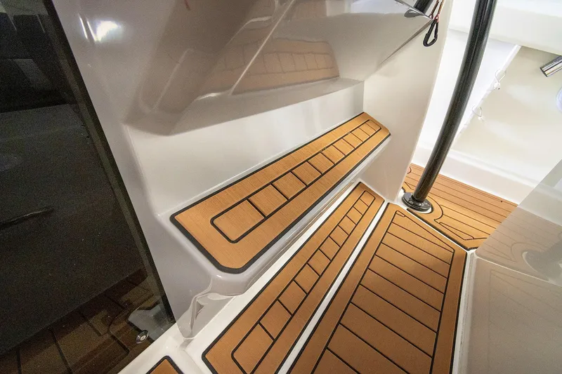  Yacht Photos Pics 2020 Jeanneau Leader 9.0 CC boat interior with teak-style flooring and sleek design.