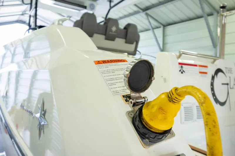  Yacht Photos Pics 2020 Jeanneau Leader 9.0 CC boat with yellow power cable in a garage.