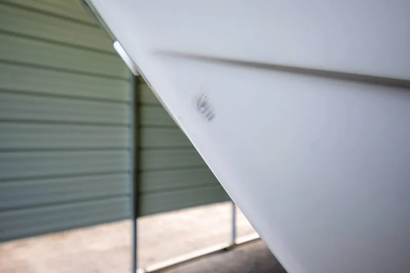  Yacht Photos Pics Close-up of 2020 Jeanneau Leader 9.0 CC boat hull in storage.