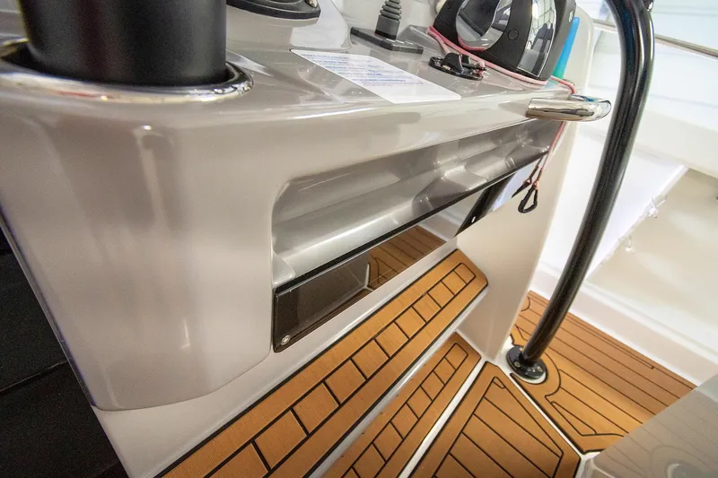  Yacht Photos Pics 2020 Jeanneau Leader 9.0 CC boat interior with teak flooring and control panel.