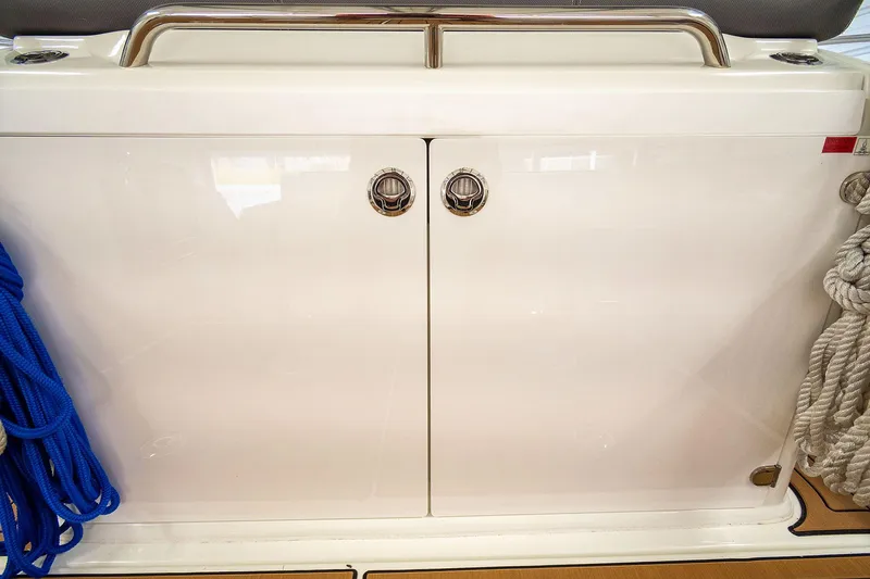  Yacht Photos Pics 2020 Jeanneau Leader 9.0 CC boat storage compartment with ropes and stainless steel handle.